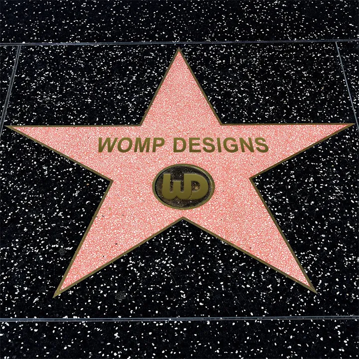 Hollywood Walk of Fame pink terrazzo star dedicated to Womp Designs with a gold Womp Designs center logo.