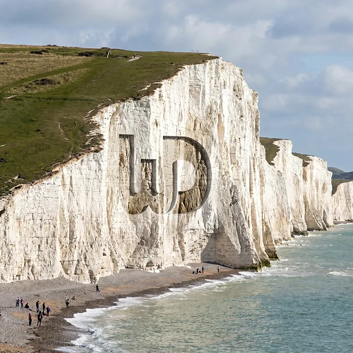 White Cliffs of Dover coastline with a giant Womp Designs logo carved into the chalk cliffside.